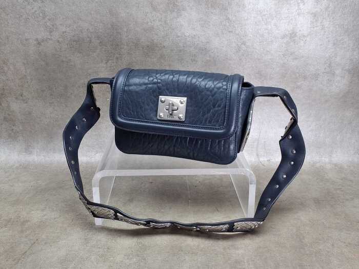 Designer-style handbag in navy and silver tones.