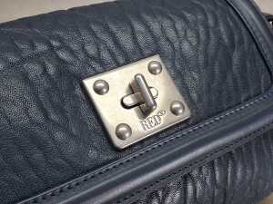Designer-style handbag in navy and silver tones. - 5