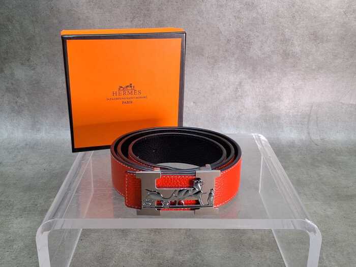 Designer-style orange belt with horse and carriage buckle