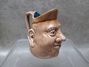 Bendigo potter face jug with brown and blue glaze.
