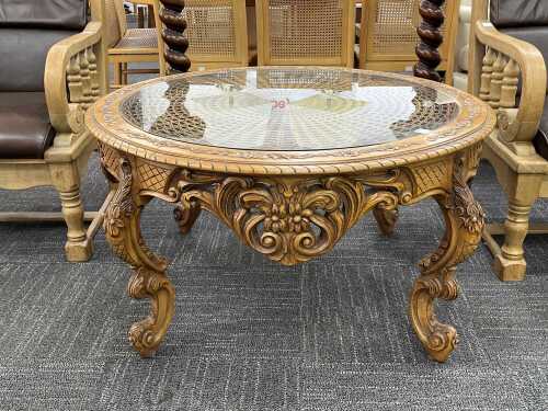 Ornate carved timber coffee table with glass top