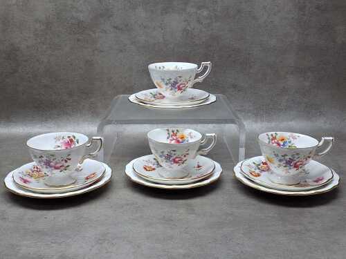 Four Royal Crown Derby porcelain trios