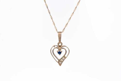 A sapphire and diamond heart necklace in 9 carat yellow gold