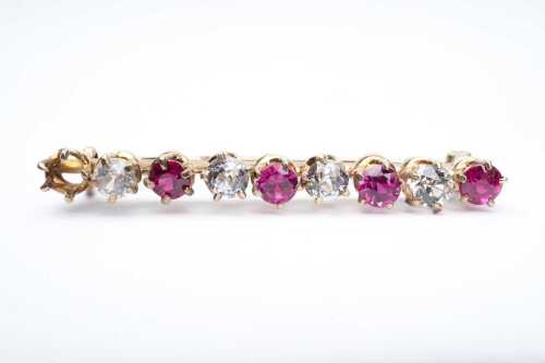 An antique ruby and diamond brooch in 15 carat yellow gold