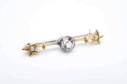 An antique white sapphire and seed pearl bar brooch in 15 carat yellow gold