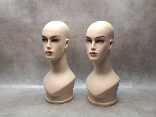 Two female mannequin head displays