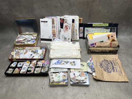 Collection of World stamps in tins and bags.