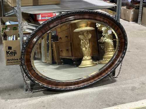 Antique oval wall mirror with ornate carved timber frame