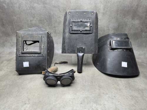 Three welding helmets and googles