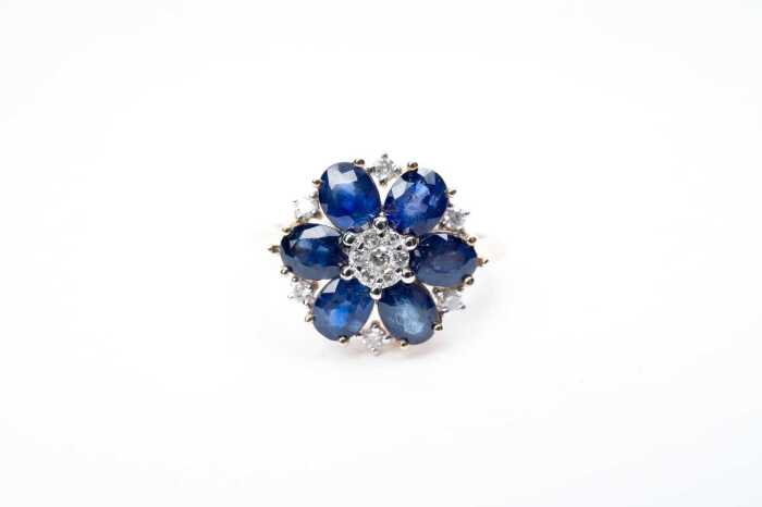 A sapphire and diamond ring in 14 carat yellow gold