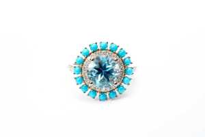 A blue topaz, diamond and turquoise ring in 14 carat yellow gold