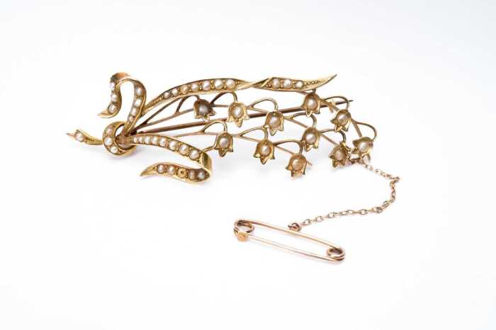 An antique seed pearl brooch in 15 carat yellow gold