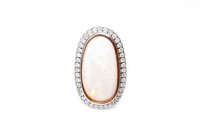 An opal and diamond ring in 14 carat rose gold