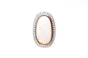An opal and diamond ring in 14 carat rose gold