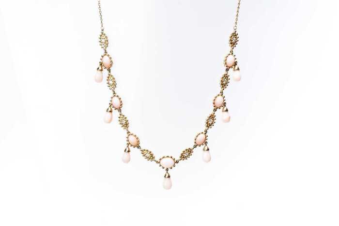 A pink opal and diamond necklace in 14 carat yellow gold