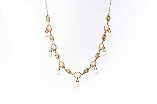 A pink opal and diamond necklace in 14 carat yellow gold