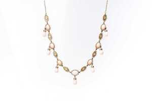 A pink opal and diamond necklace in 14 carat yellow gold