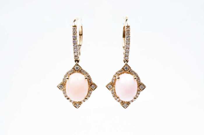 A pair of pink opal and diamond earrings in 14 carat yellow gold