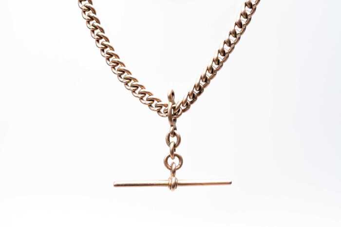 An antique curb link fob necklace in 9 carat rose gold