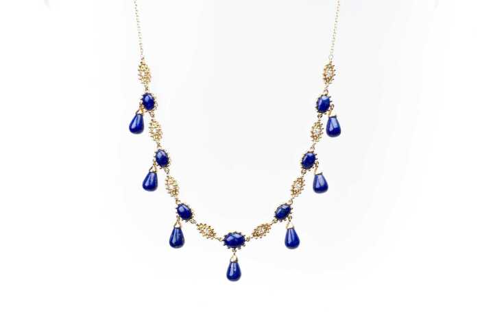 A lapis lazuli and diamond necklace in 14 carat yellow gold