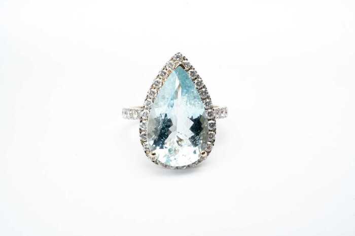 An aquamarine and diamond ring in 14 carat yellow gold