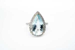 An aquamarine and diamond ring in 14 carat yellow gold