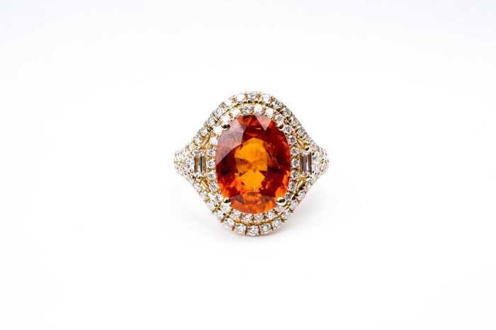 An orange citrine and diamond ring in 14 carat yellow gold