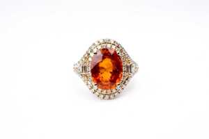 An orange citrine and diamond ring in 14 carat yellow gold