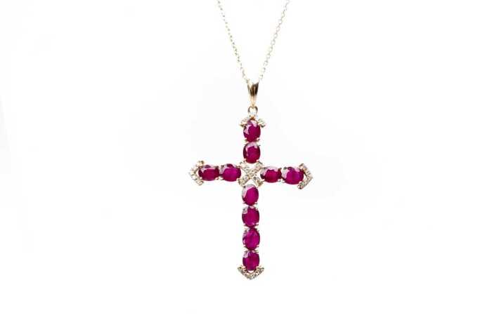 A ruby and diamond cross and necklace in 14 carat yellow gold