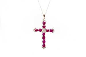 A ruby and diamond cross and necklace in 14 carat yellow gold