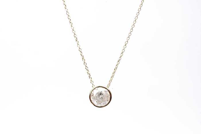 A diamond slider pendant on necklace in 14 carat yellow gold