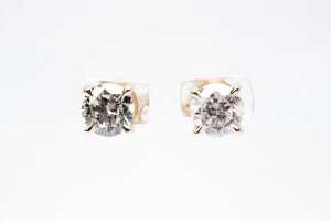 A pair of diamond stud earrings in 14 carat yellow gold