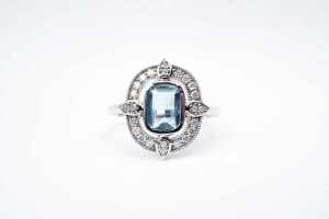 An aquamarine and diamond ring in 14 carat white gold