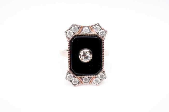 An onyx and diamond ring in 14 carat rose gold