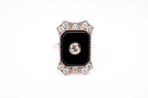 An onyx and diamond ring in 14 carat rose gold