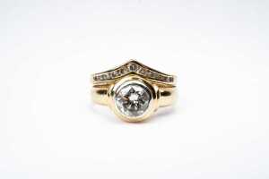 A diamond ring set in 18 carat yellow gold