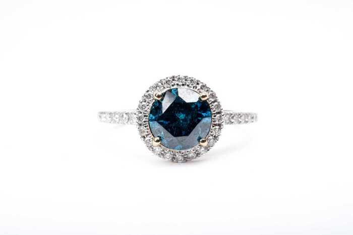 A treated blue and white diamond ring in 14 carat yellow gold
