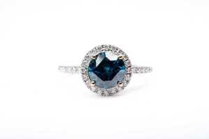 A treated blue and white diamond ring in 14 carat yellow gold