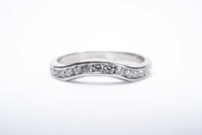 A diamond fitted wedding band in platinum