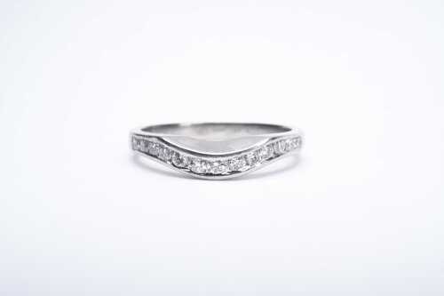 A diamond fitted wedding band in platinum