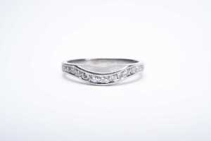 A diamond fitted wedding band in platinum