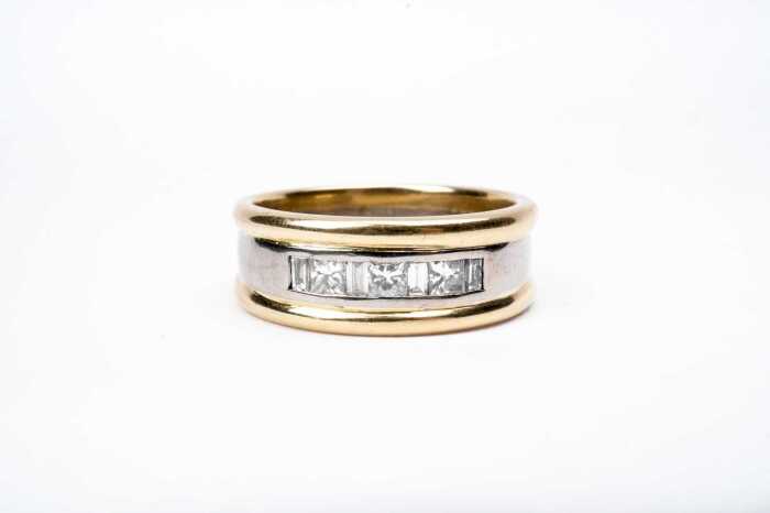 A diamond gents ring in 18 carat yellow and white gold