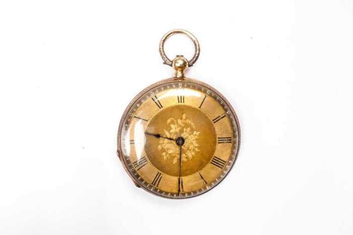 An antique pocket watch in 18 carat gold