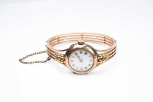 An antique ladies bangle watch in 9 carat yellow gold.