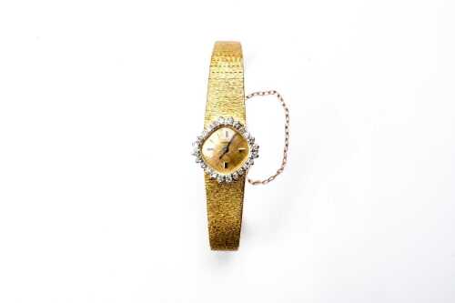 A vintage diamond Longines watch in 18 carat yellow gold