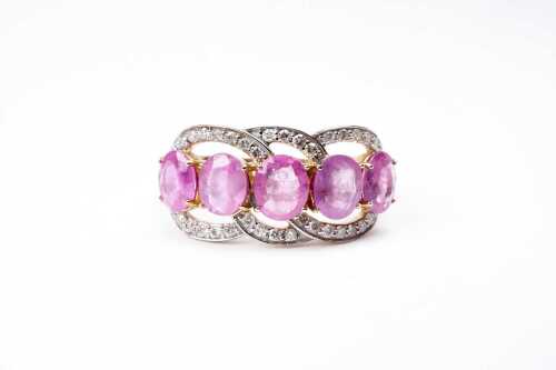 A pink sapphire and diamond ring in 14 carat yellow gold