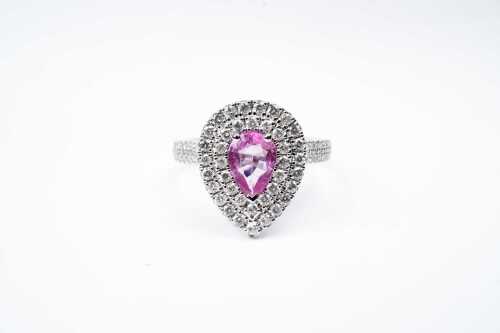 A pink sapphire and diamond ring in 14 carat white gold