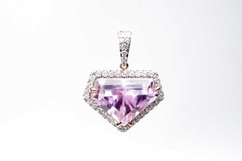 A kunzite and diamond pendant in 14 carat rose gold