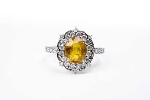 A yellow sapphire and diamond ring in 14 carat white gold