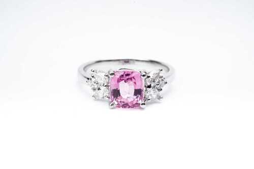 A pink sapphire and diamond ring in 18 carat white gold
